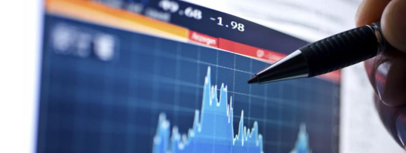 Pen held over a performance graph