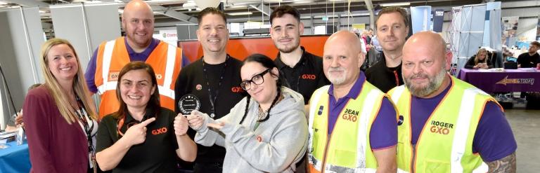 Workers posing with an award